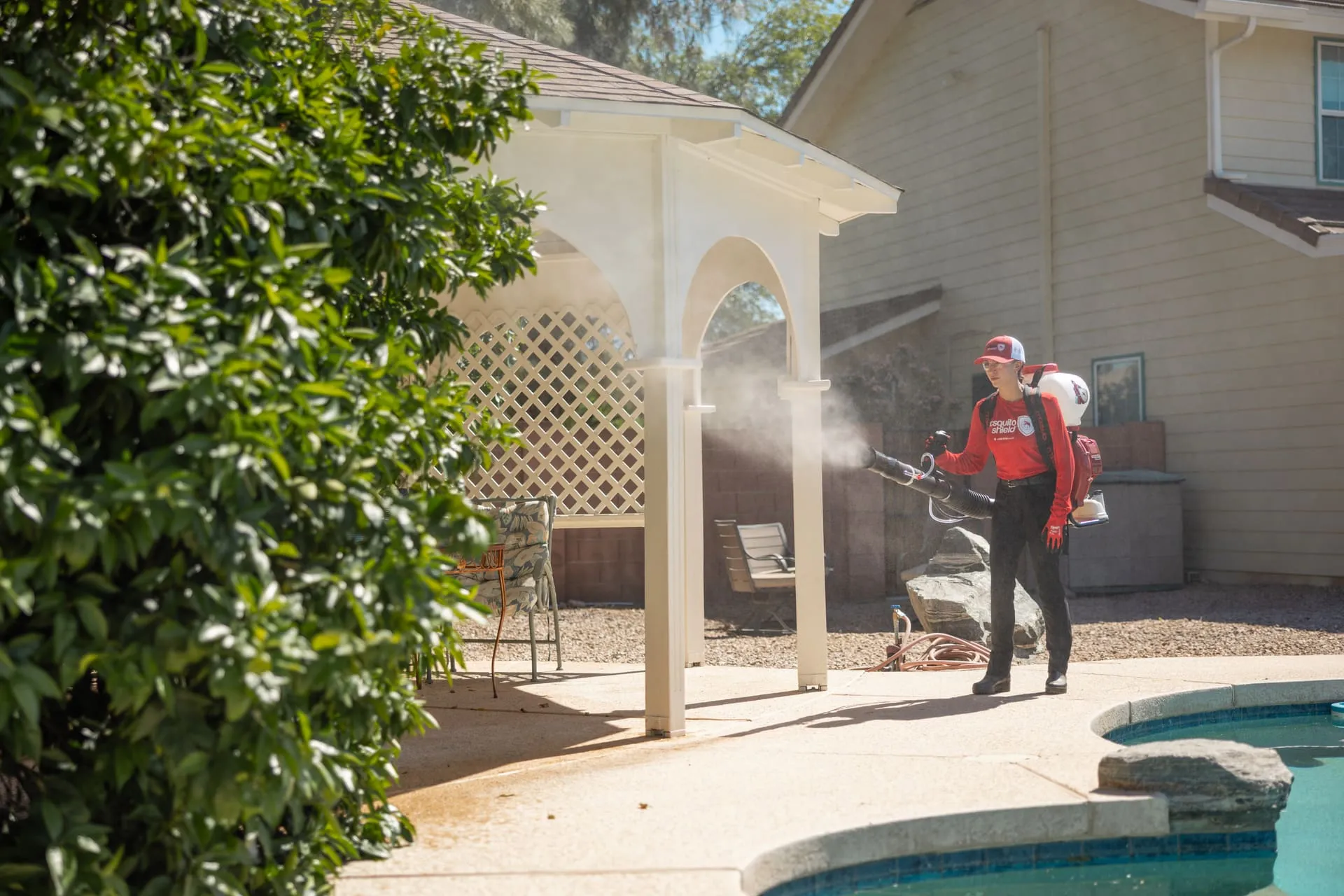Mosquito Shield technician treating a luxury South Florida waterfront property