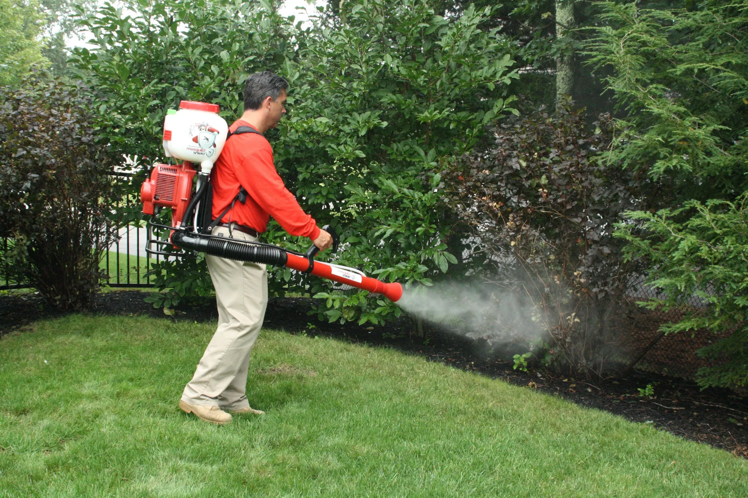 Mosquito Shield technician applying barrier spray treatment in South Florida